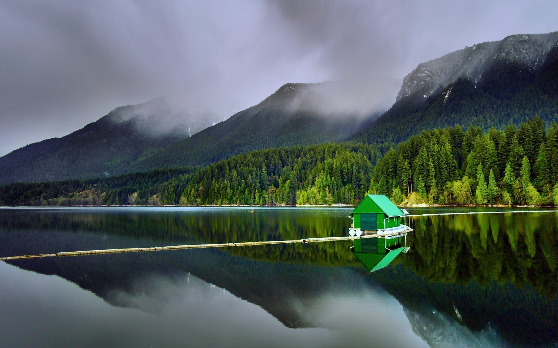 Misty lake with green boathouse in British Columbia — VisaScope