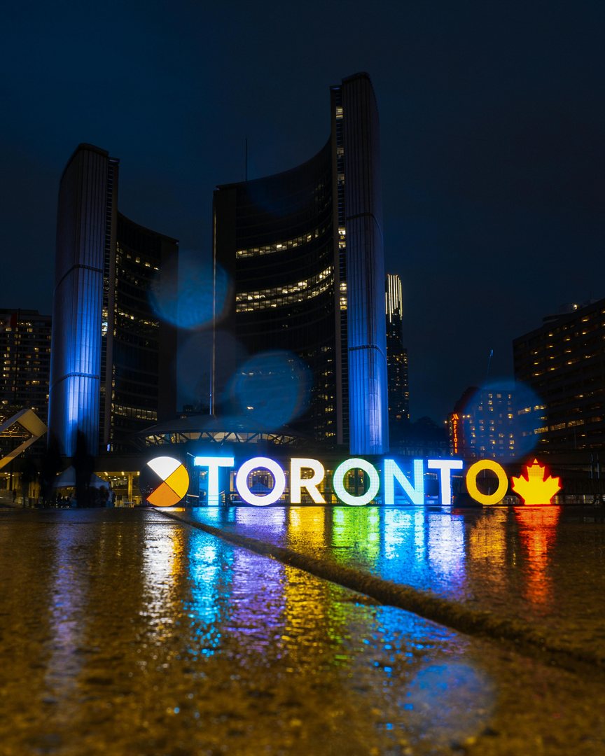 Toronto sign illuminated at night — VisaScope
