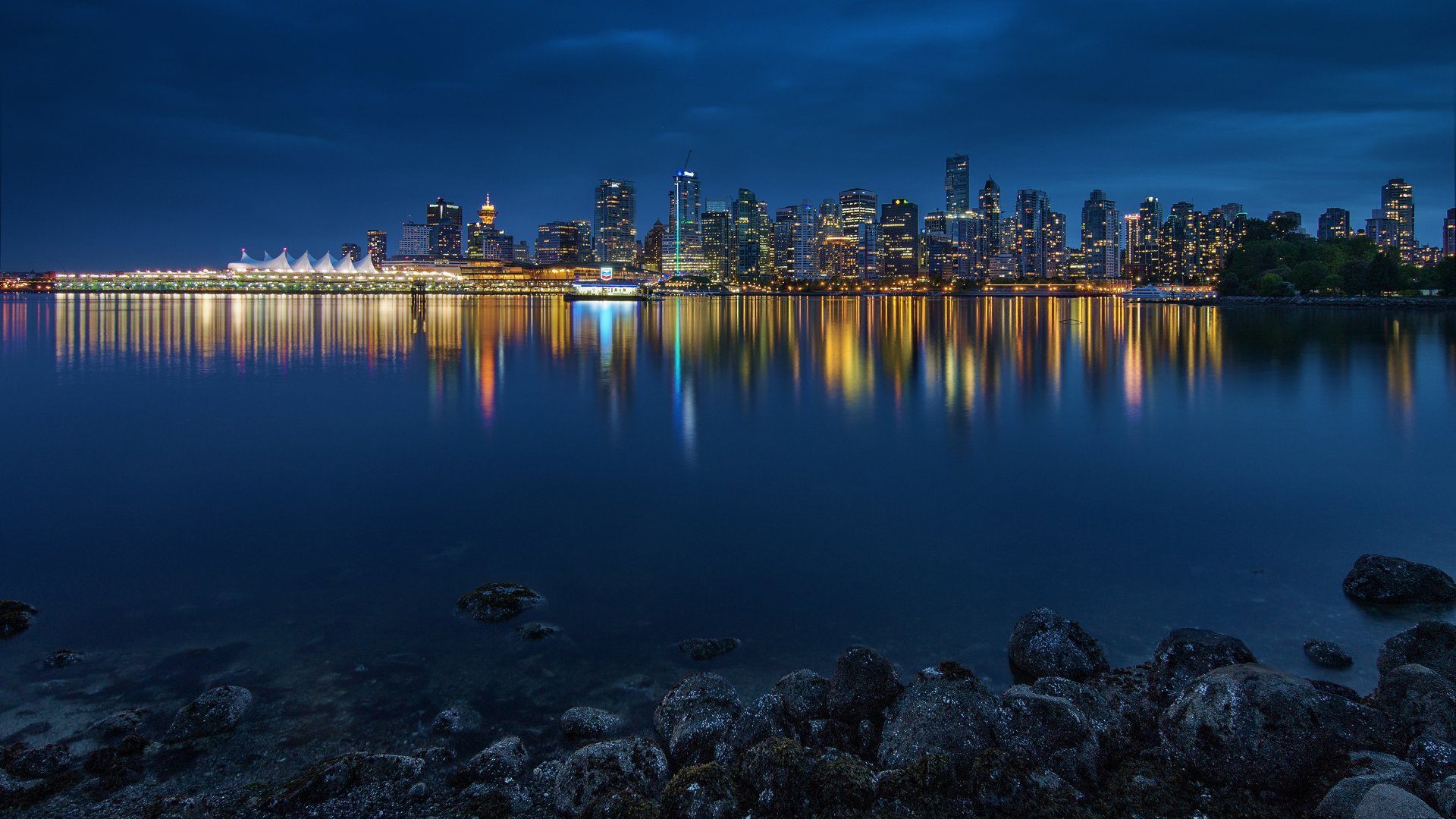 Vancouver night skyline reflected in water — Immigrate to Canada